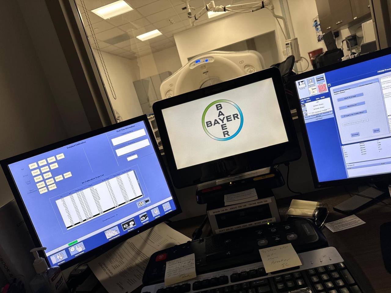 CT scanner control room with Bayer injector console and system monitors.