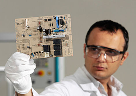 MIS engineer inspecting electronics